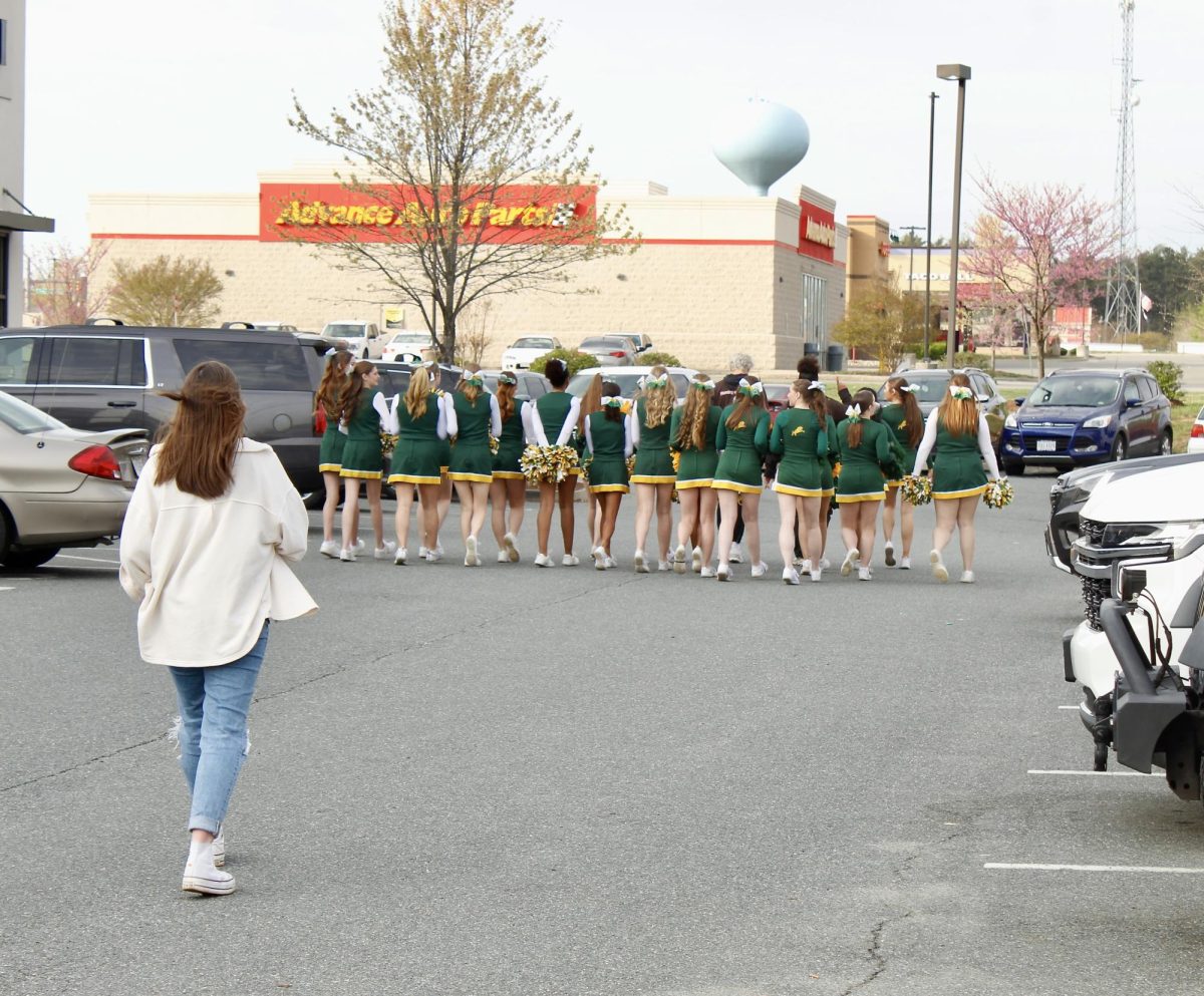 Louisa Lions cheerleaders walk together followed by leadership member Melinda Staudinger.