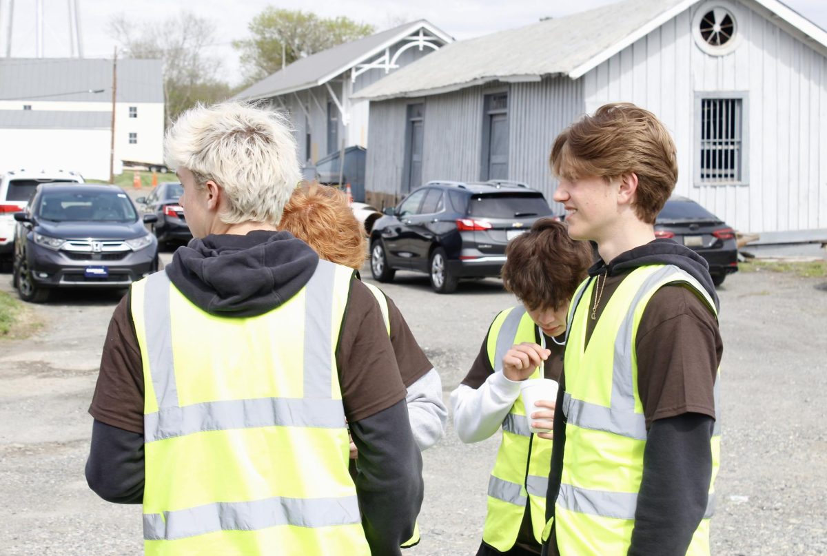 Leadership members Hudson McDougall and Ethan McGehee help organize parking and control traffic. 
