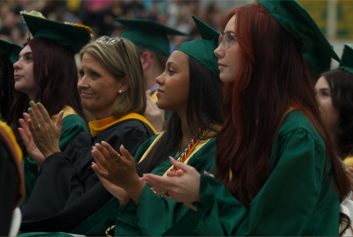 Graduates clap for their fellow class members after they finish their speeches.