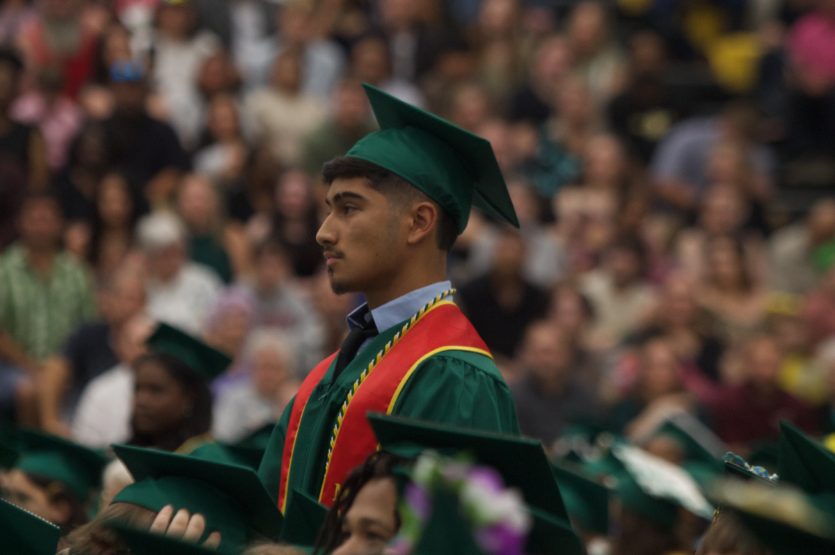 Graduate Ian Castillo stands up to represent his commitment to joining the United States Marines.
