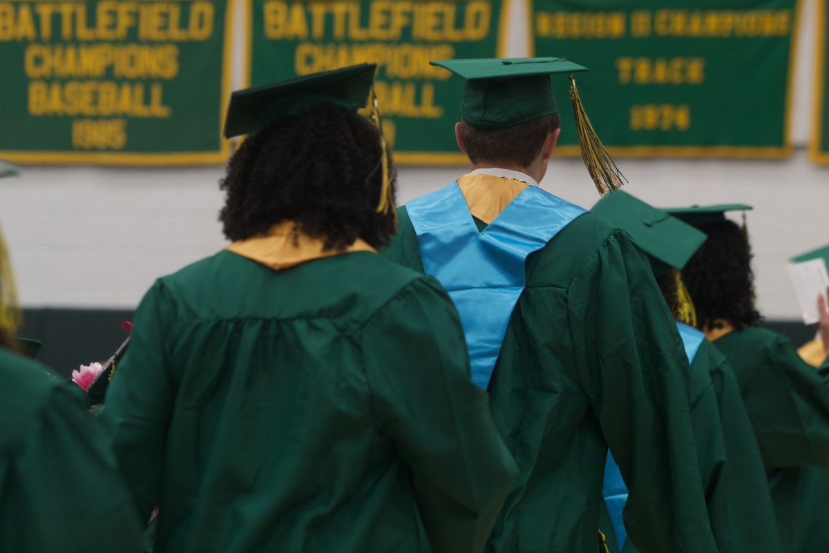 Seniors being guided by the junior marshalls to the stage.
