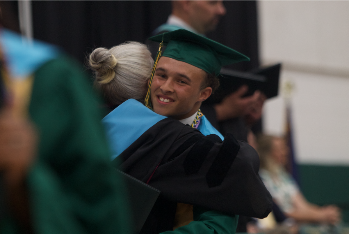 Graduate Isaiah Holland hugs Dr. Thiemann for helping him throughout his years in high school. 