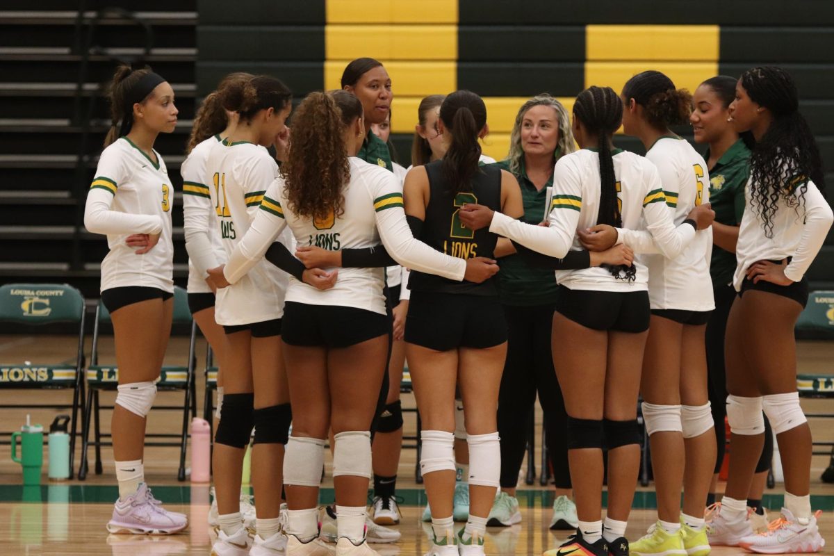 The volleyball team huddles up, discussing the game plan and what to do