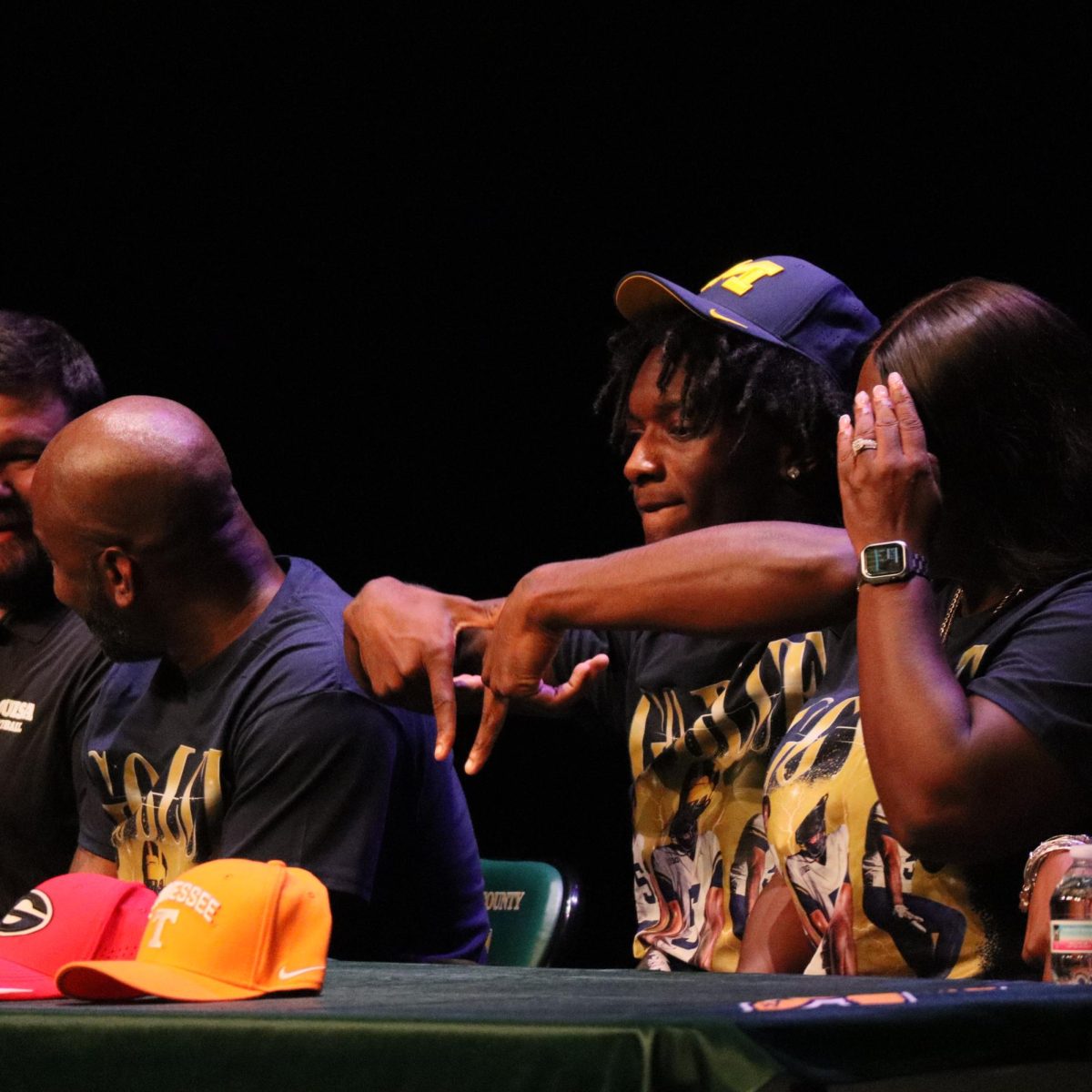 Hiter signals the Michigan "M" to the computer screen that live streamed his commitment.