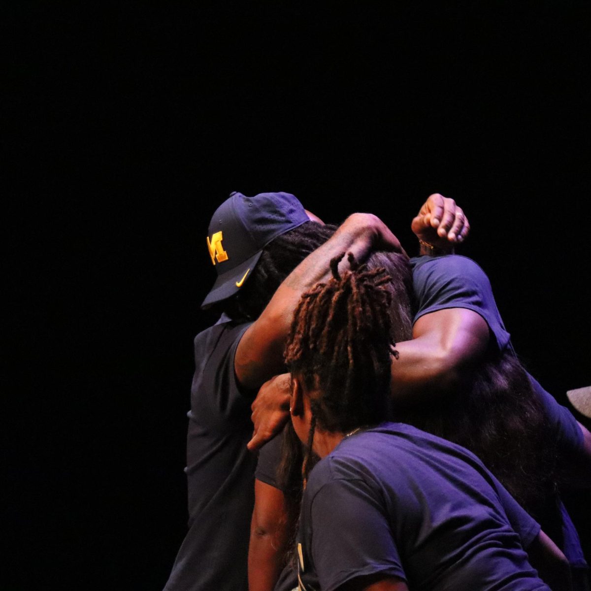 Hiter is emotional as he hugs his parents after announcing his commitment to the University of Michigan.