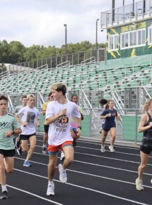 While doing striders, senior Alexander Hurst-Barbeito looks back and laughs at a comment made by his fellow teammate.  