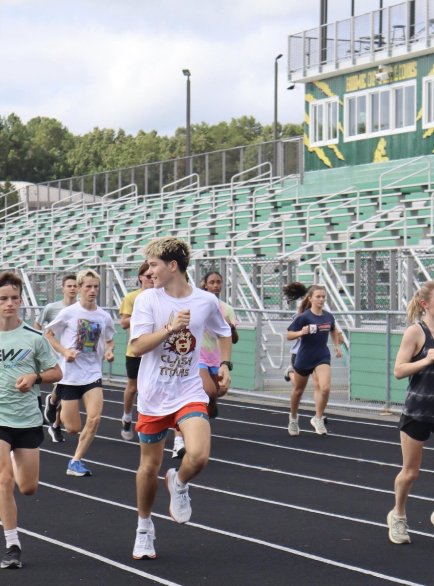 While doing striders, senior Alexander Hurst-Barbeito looks back and laughs at a comment made by his fellow teammate.  