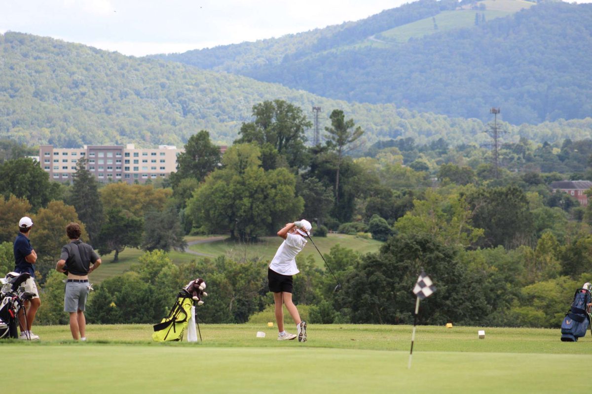 Sophomore Evan Snead is in his follow-through after hitting his drive at the driving range. 