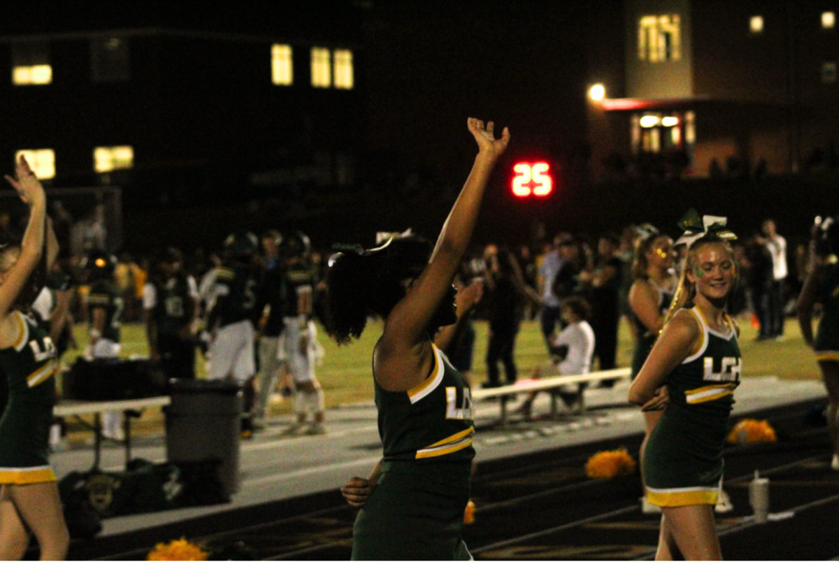 Junior, London Long, waves as she creates an enthusiastic atmosphere amongst the crowd. 