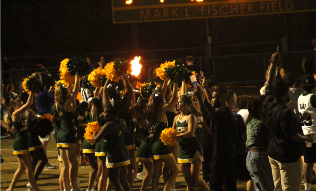 The cheer team gathers in excitement after a touchdown in the third quarter.