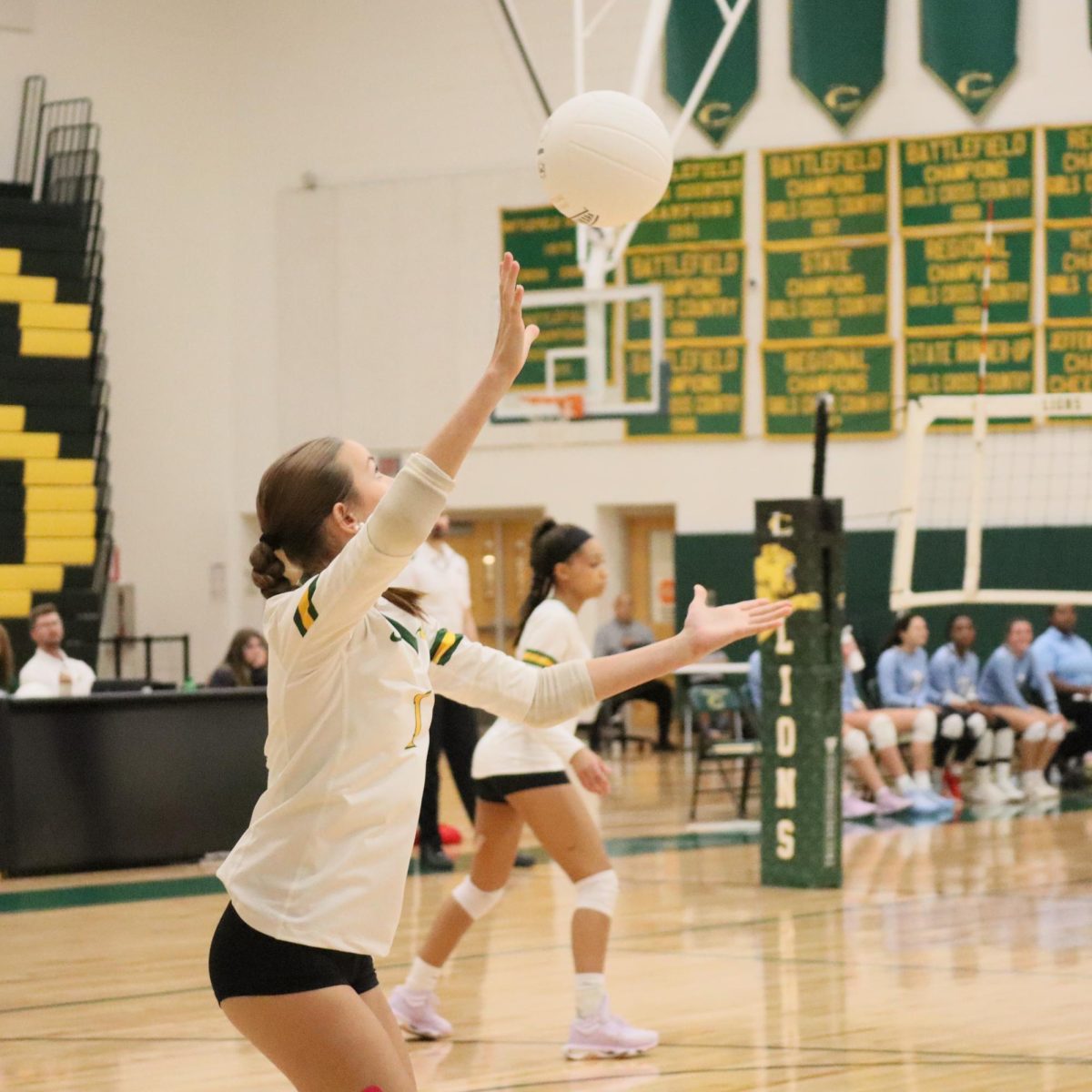 Freshman Maci Hensley prepares to serve the ball to the other team.
