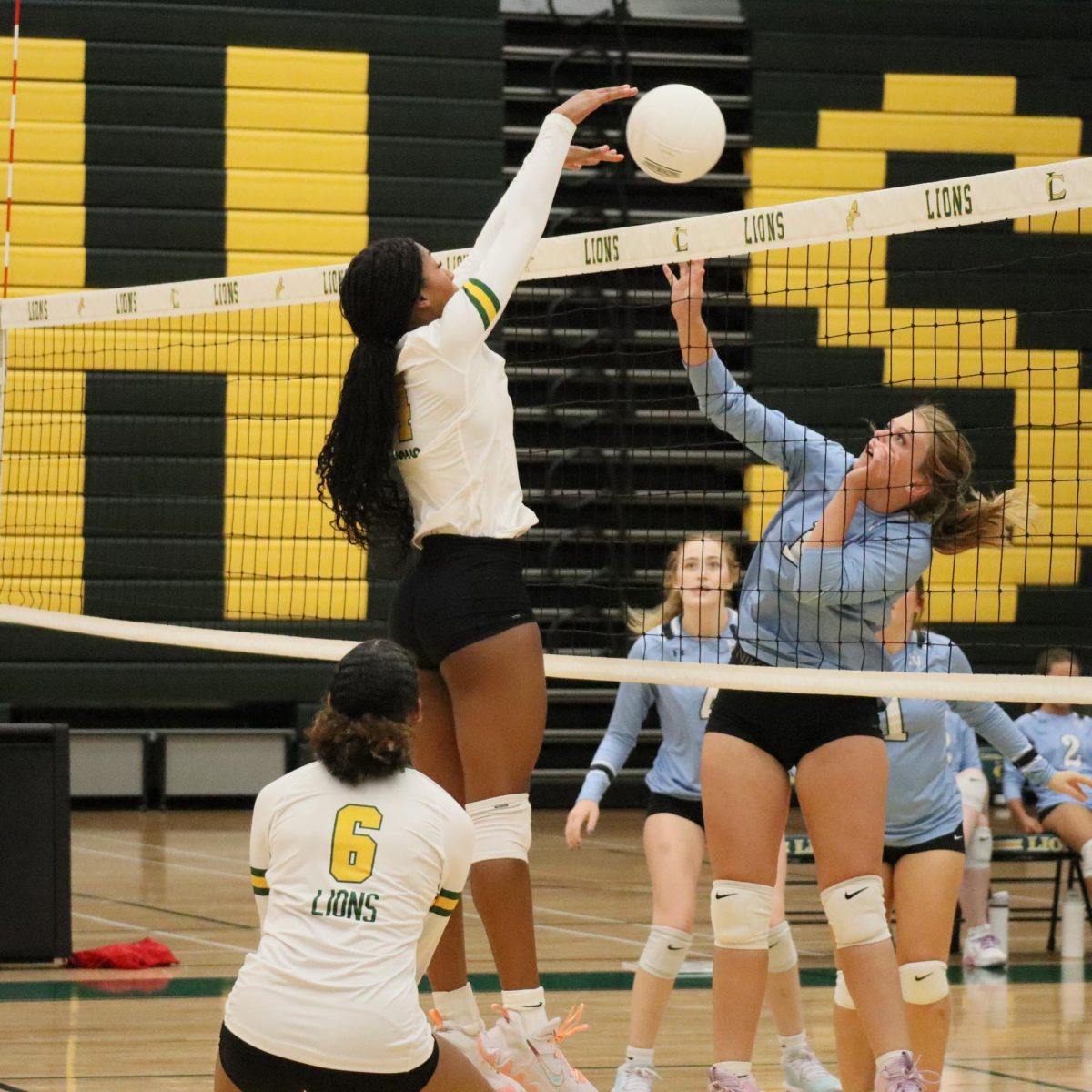 Senior Isabella Williams blocks the ball and scores a point for her team.