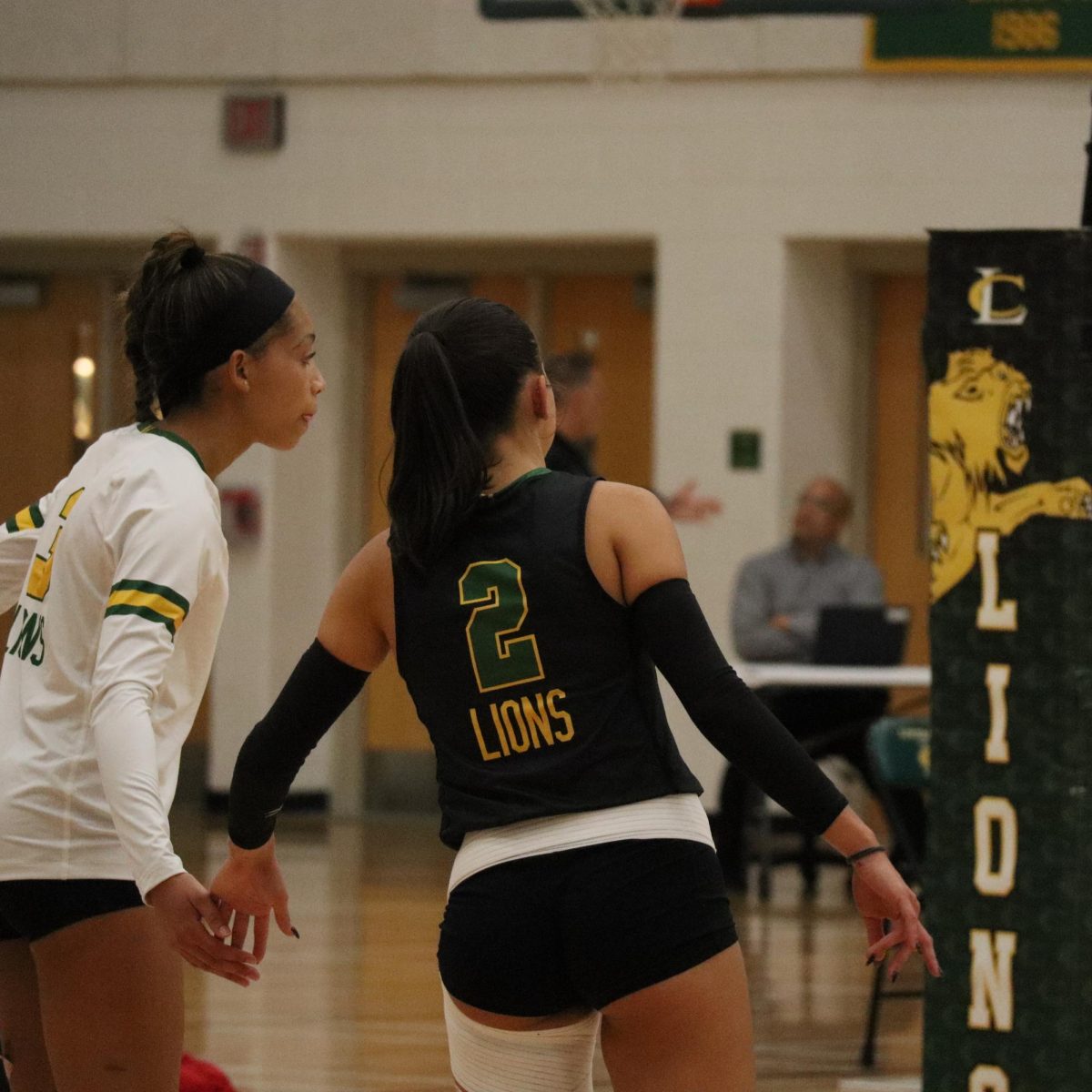 Captain Elliott Moreno gives a high-five to her teammate, Kristen Martinez, before the next play.