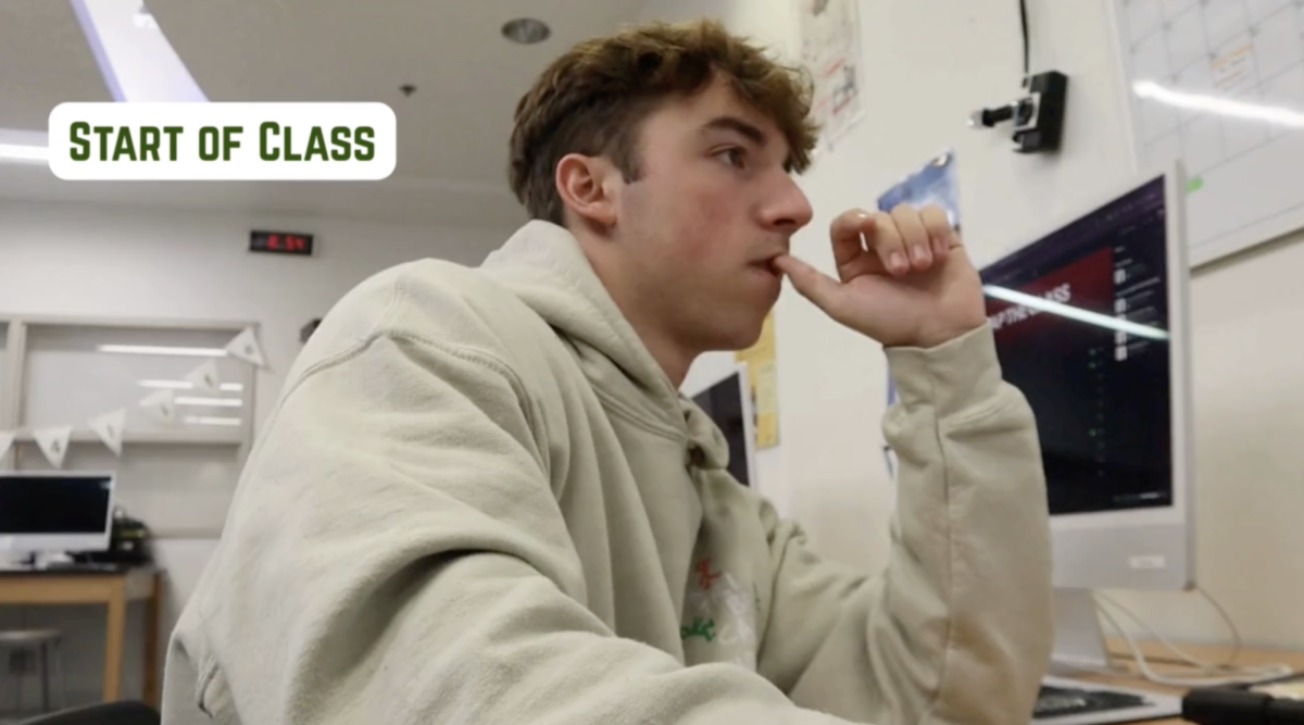 Cover for behind the scenes of the newspaper class featuring newspaper member Ben Stallard at the start of class.