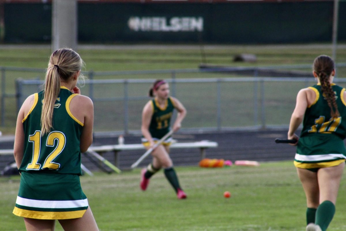 Junior, Logan Clements warms up with her teammates before the game.