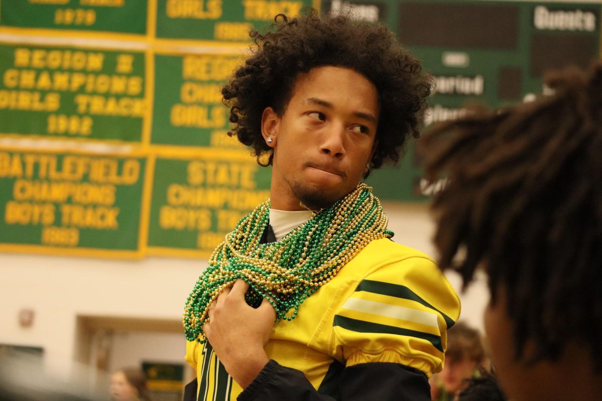 Senior Tyreek Tison wears beaded necklaces to show the amount of rock-paper-scissor battles he has won.