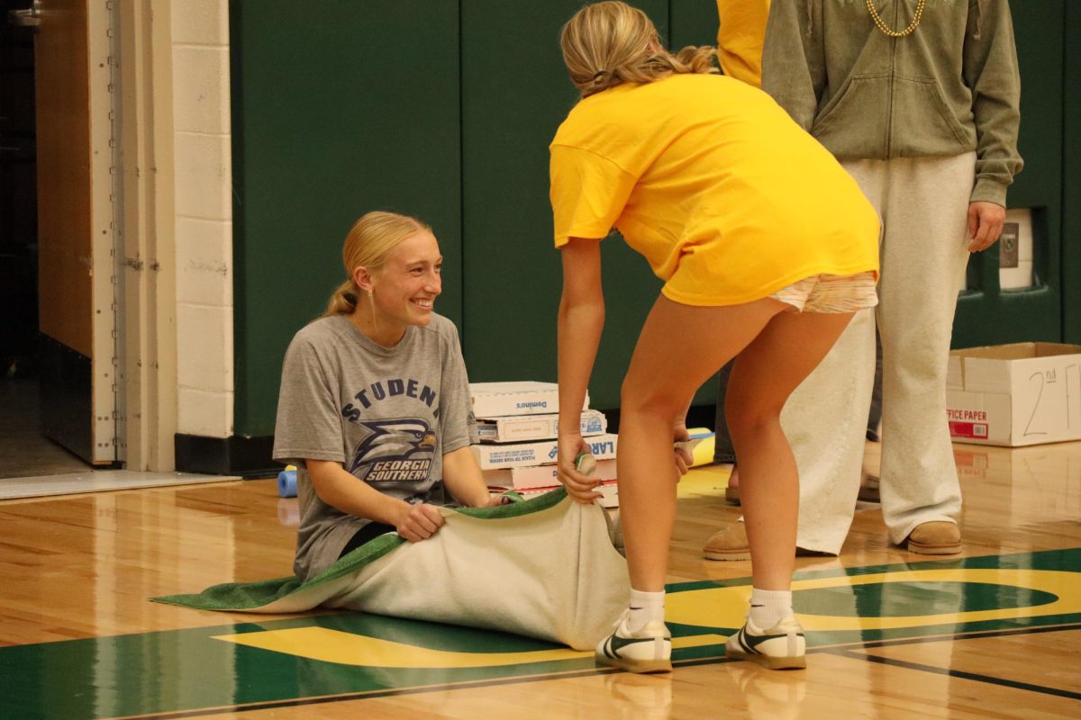 Senior Elizabeth Middlesworth participates in the rug race with her peer Ava Garrison. 