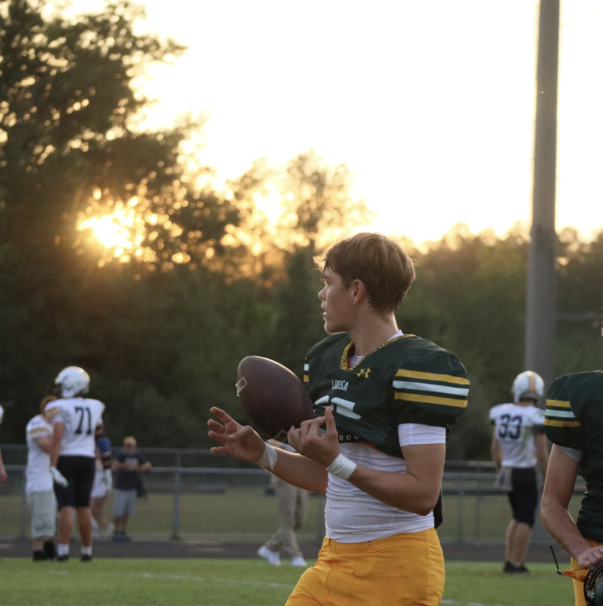 Senior Jonathon Jarvis warms up with his team before the game. 