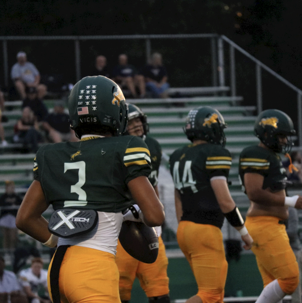 Running back Dustin Nelson jogs back to the line after completing a play.

