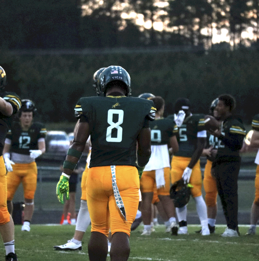 Creasy walks back towards his warm up line where they practice their plays.
