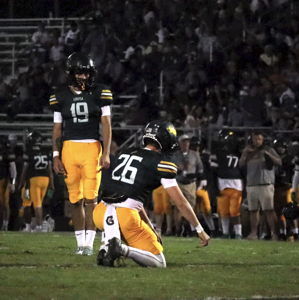 Kicker Bence Buri counts his steps for the extra point after a Louisa touchdown. 
