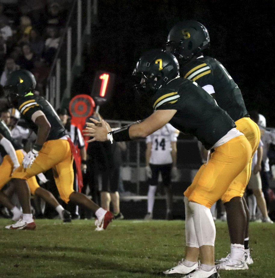 Quarterback Levi Wilson calls for the snap from the center. 
