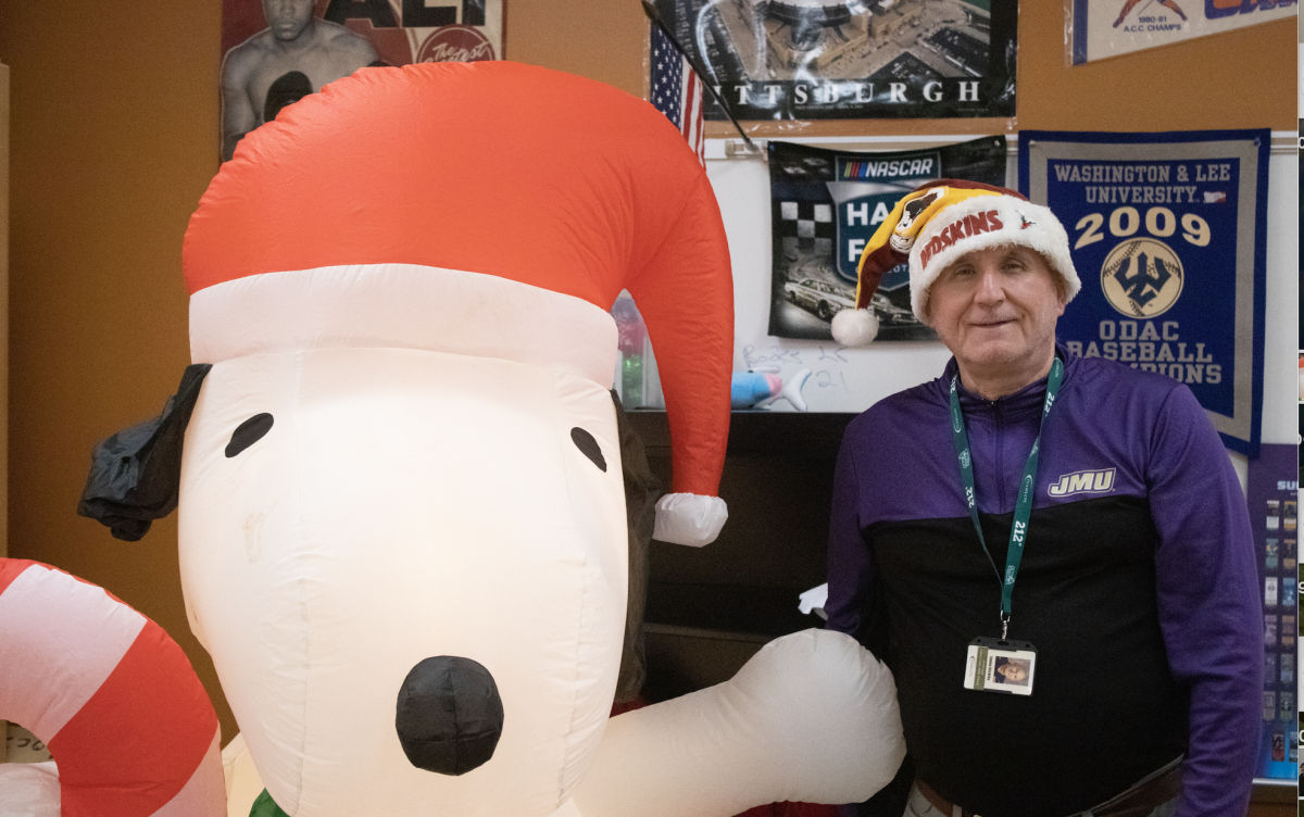 Jimmy Stickley shows off his inflatable Snoopy in front of his classroom.
