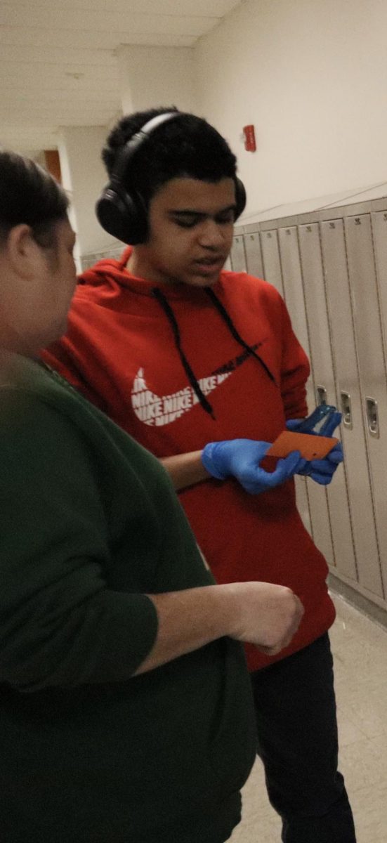 Sophomore Gabriel Carter stamping a coffee card.