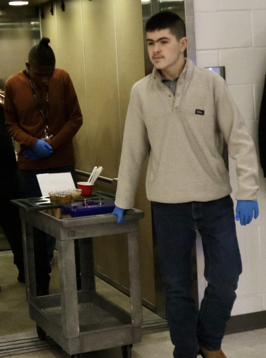  Junior Noah Young and Swingle walking out to the elevator to give coffee to the cafeteria workers.