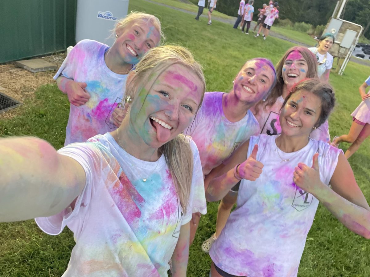 Senior Kara Kotowski's group a photo after participating in the Student Life Color Wars. 