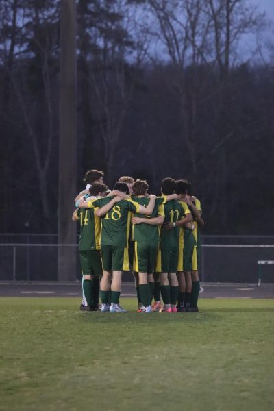 Starting boys varsity soccer team come in for a pep-talk before the start of the game.