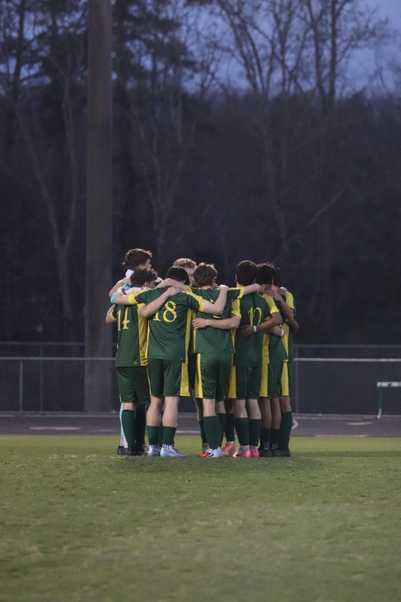 Starting boys varsity soccer team come in for a pep-talk before the start of the game.
