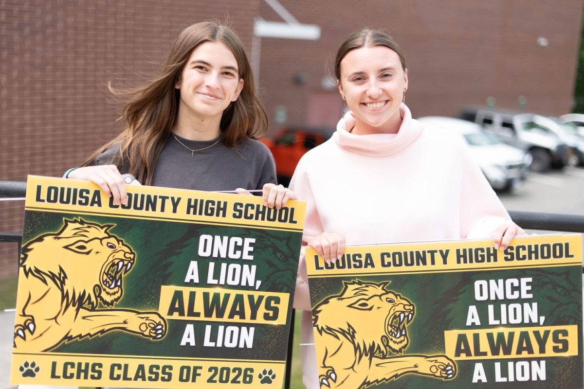 Delaney and  I posing after graduation practice with our yard signs.